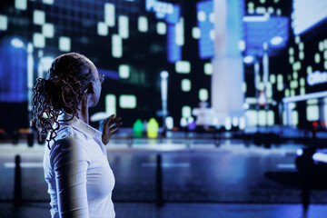 Woman wandering around city boulevards during nighttime, being amazed by urban landscape buildings....