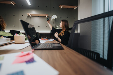 In a modern office, diverse colleagues collaborate around a table filled with laptops and papers, discussing and brainstorming ideas enthusiastically.