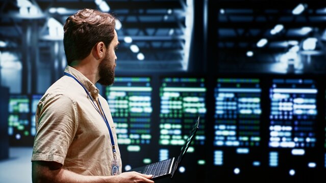 System administrator in server farm using renewable hydro energy sources to power blockchain mining operations. Specialist working with eco friendly supercomputers preventing environmental impact