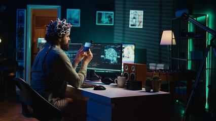 IT specialist using EEG headset and deep learning technology to upload brain into computer. Close...