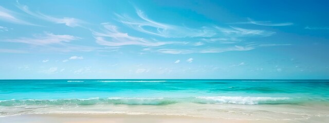 Obraz premium Tranquil beach with turquoise waves and clouds. Calm seashore with blue sky and clear waters. Concept of nature, relaxation, tropical destinations, vacation. Wide banner. Copy space