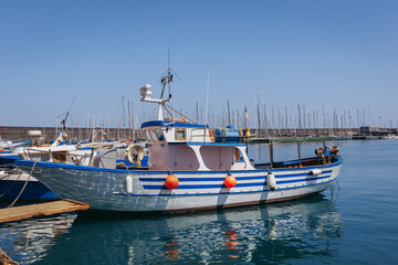 Fishing boat in port in Catania city on the island of Sicily, Italy - obrazy, fototapety, plakaty