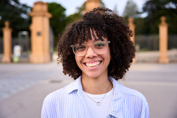 Close up head shot beautiful Latin American teen school girl single happy looking at camera. Wide...