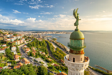Plakat Faro della Vittoria lighthouse in Trieste city at sunny day, Italy