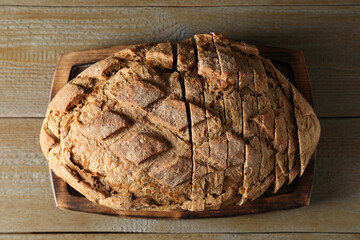 Freshly baked cut sourdough bread on wooden table