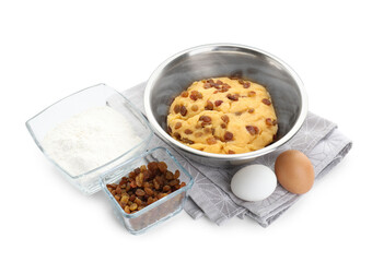 Dough with raisins in bowl, flour and eggs isolated on white