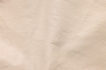Beige natural leather as background, top view