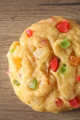 Raw dough with candied fruits on wooden table, top view