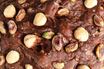 Raw chocolate dough with nuts as background, top view