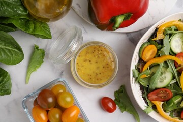 Tasty vinegar based sauce (Vinaigrette) in jar, salad and products on white marble table, flat lay