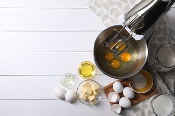 Making dough. Raw eggs in bowl of stand mixer and ingredients on white wooden table, flat lay with...