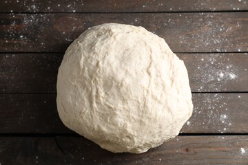 Raw dough on wooden table, top view