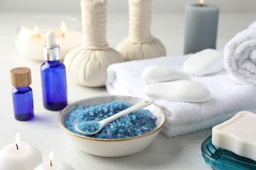 Spa composition. Cosmetic products, soap, towels, sea salt and burning candles on light table