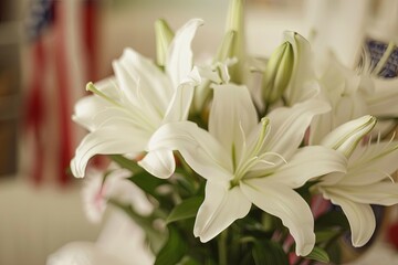 Obraz premium Elegant Floral Arrangement Featuring White Lilies and Red Roses With a Blurred American Flag Background