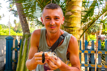 Man holds baby sea turtle hawksbill turtle loggerhead sea turtle.