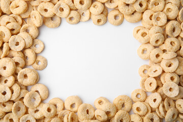Naklejka premium Frame made of cereal rings on white background, top view. Space for text