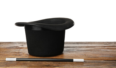 Magician's hat and wand on wooden table against white background