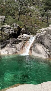 PAN SHOT The Po&ccedil;o Azul (Blue Well) is an idyllic lagoon with crystal-clear water that comes from the Landeira stream, which flows through granitic rocks to create a waterfall in the Peneda-Ger&ecirc;s Park.
