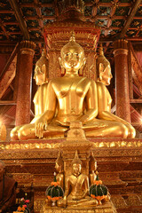 Four Buddha statues in the posture of Maravichai, facing out to the gates in all four directions, with bases built inside Buddhist Church at  Wat Phumin. Located at Nan Province in Thailand.