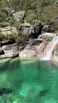 PAN SLOW The Po&ccedil;o Azul (Blue Well) is an idyllic lagoon with crystal-clear water that comes from the Landeira stream, which flows through granitic rocks to create a waterfall in the Peneda-Ger&ecirc;s Park.
