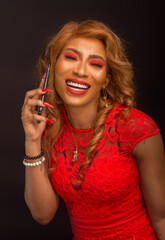 A portrait of a pretty African lady in a red dress making a phone call