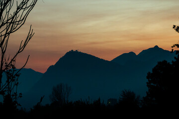 Sunset with misty blue mountains