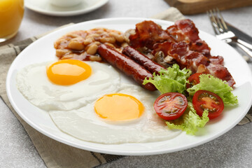 Delicious breakfast with sunny side up eggs on light table, closeup