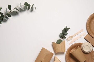Eco friendly food packaging. Paper containers, tableware and eucalyptus branches on white...