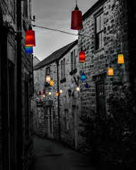 Lights illuminate a narrow alley between buildings