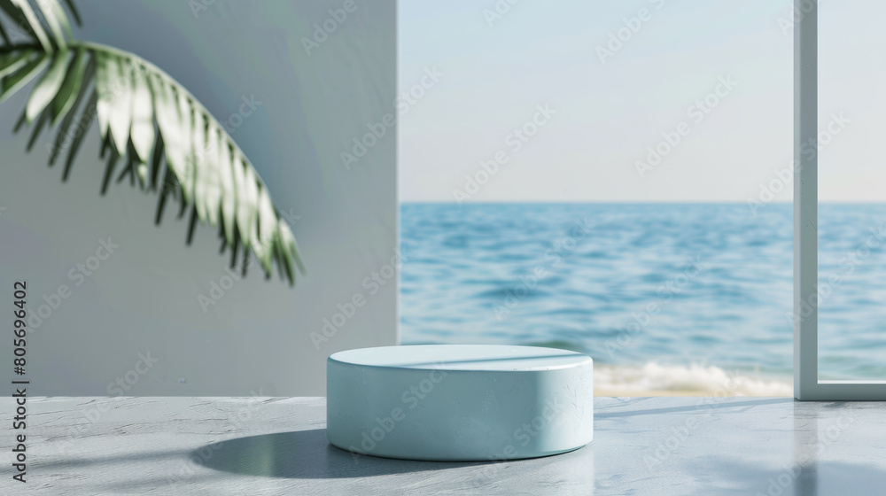 Poster a blue round table is in front of a window with a view of the ocean