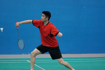 A very focused young player who plays single badminton.