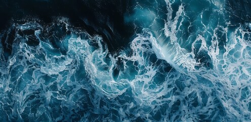 A closeup of the bottom left corner of an ocean wave, capturing its powerful movement and blue hues