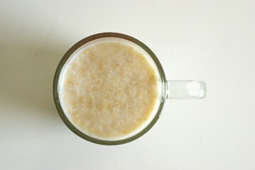 Top view of cereal in a cup for breakfast, oat with milk in a glass cup