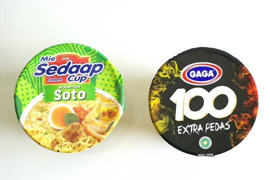 ogyakarta, Indonesia - May 05, 2024. Two different brands of Indonesian instant noodle cups are isolated on a white background. Gaga mie 100 and Mie sedap noodle cup