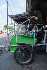 Indonesian pedicab or BECAK side view as traditional three wheels cab for local transportation