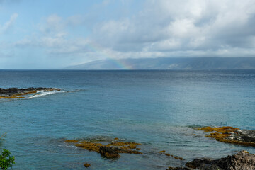 Beautiful panoramic Kapalua Bay vista with a rainbow over the Molokai island visible in a distance, Maui, Hawaii