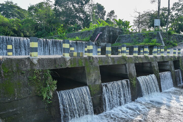 Water fall dam landscape and bridge view with blue sky background in Lojajar village, Yogyakarta, Indonesia