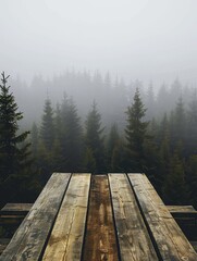 A pile of wooden construction materials with a misty foggy pine tree forest behind it.
