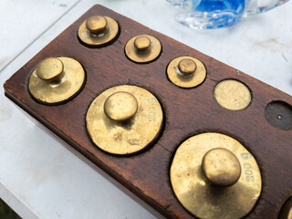 Vintage Brass Weights Collection on Wooden Block