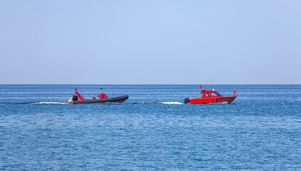 A Coast Guard rescue boat is towing a second patrol boat.
