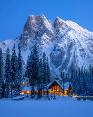 Beautiful big mountain view in Canada during winter time. Emerald lake as foreground has frozen over and covered with snow.