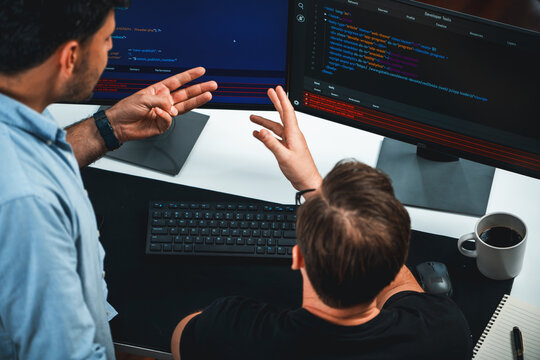 IT developers discussing online software development information on pc screen, creating program coding for latest version application on website. Concept of brainstorming firmware updated. Sellable.