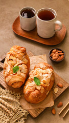 Gluten free Almond Breads and two cups of tea served on the grey background with almond condiments