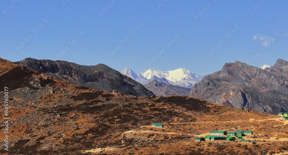 Wall mural snowcapped himalaya mountains and remote countryside area of tawang near bum la pass, arid alpine landscape of arunachal pradesh, north east india