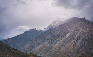 Fototapeta premium Mountain range with freshly fallen snow in cloudy weather in the mountains