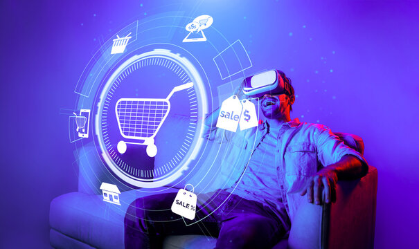 Happy man using VR headset and shopping online while sitting at sofa with shopping bags. Smart person looking at online market hologram and icon with neon background. Innovation technology. Deviation.