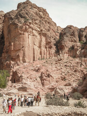 Numerous tourists travel through remains of Nabatean buildings in the Petra historical center in...
