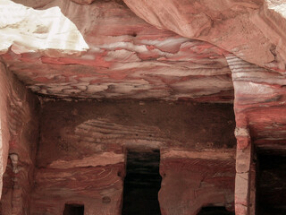 Fancy  colorful patterns of rock in a room carved into the rock in Petra historical center in Wadi...