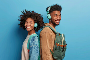 an attractive mixed race couple, wearing white headphones and smiling at each other on blue background