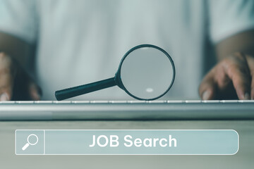 A black magnifying glass was put on the keyboard and search job text on search bar. Job searching online. Surfing the net to find occupation. The concept of resource, choice, and executive